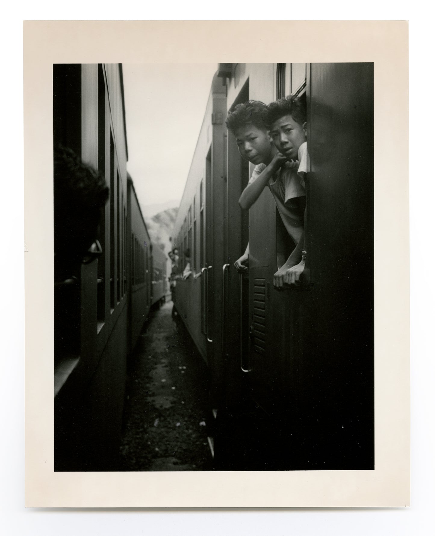 Two boys on train looking out
